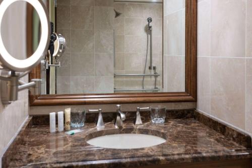紐約的住宿－The Blakely by LuxUrban，浴室的柜台设有水槽和镜子