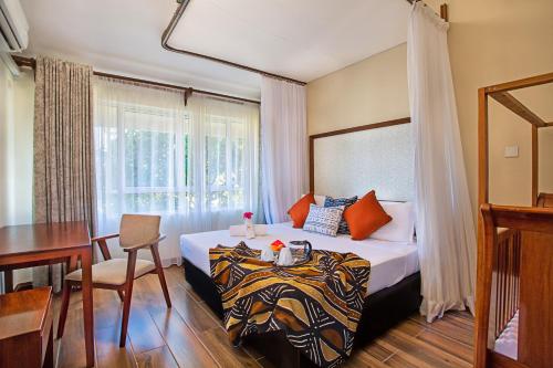 Ένα ή περισσότερα κρεβάτια σε δωμάτιο στο SWAHILI BEACH APARTMENTS