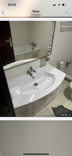 a bathroom with a white sink and a mirror at Appartement in Casablanca