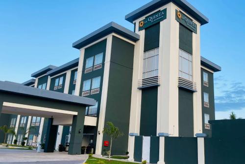 a green and white building with a sign on it at La Quinta by Wyndham Reynosa in Reynosa