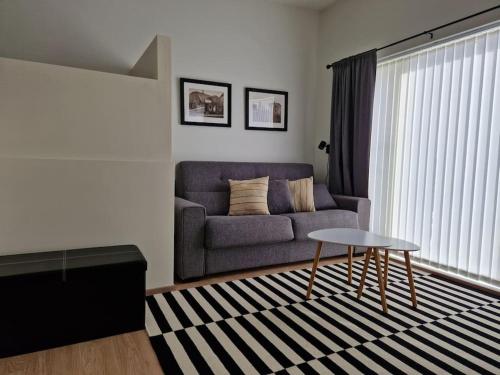 a living room with a couch and a table at MainStreet20 in Stykkishólmur
