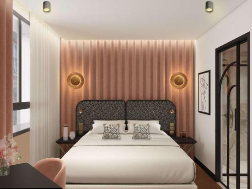 ein Schlafzimmer mit einem großen weißen Bett mit zwei Kissen in der Unterkunft Hotel Maison Hamelin Paris - Handwritten Collection in Paris