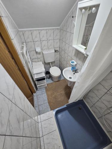 an overhead view of a bathroom with a toilet and a sink at House Petra in Rakovica