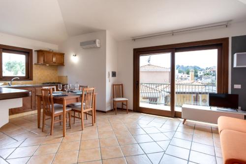Una cocina y una sala de estar con mesa y sillas. en Mirto 4 Apartment, en Santa Maria Navarrese