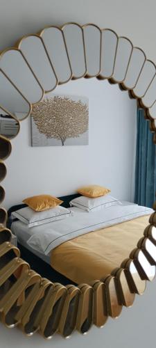 a bedroom with a bed with a mirror above it at Parc Central Republicii 63 in Baia Mare