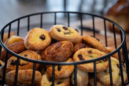 a basket filled with different types of pastries at Kyriad Prestige Saint-Malo in Saint Malo