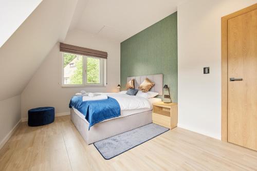 a bedroom with a bed and a window at EveRest Apartamenty Szczyrk in Szczyrk