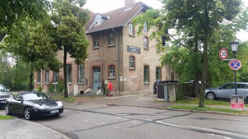 a black car parked in front of a brick building at Bright by Trade Fair ICM 15 min direct to City Center 2-BedRoom full 2-BathRoom, free Parking, Balcony, Family and Business friendly in Feldkirchen