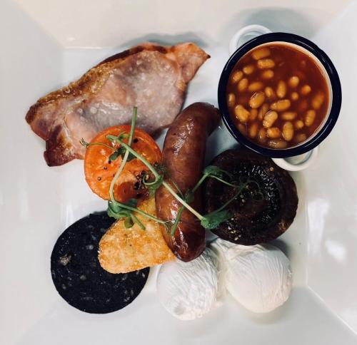 a plate of food with sausage beans and beans at Middle House in Askrigg