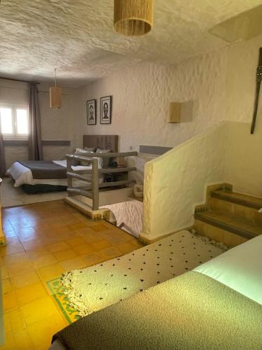 a living room with a couch and a table at Riad Al Madina in Essaouira