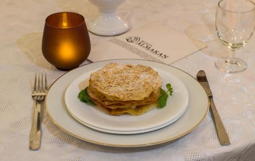 a white plate with a sandwich on a table at Riad Al Makan Fes & Spa in Fès
