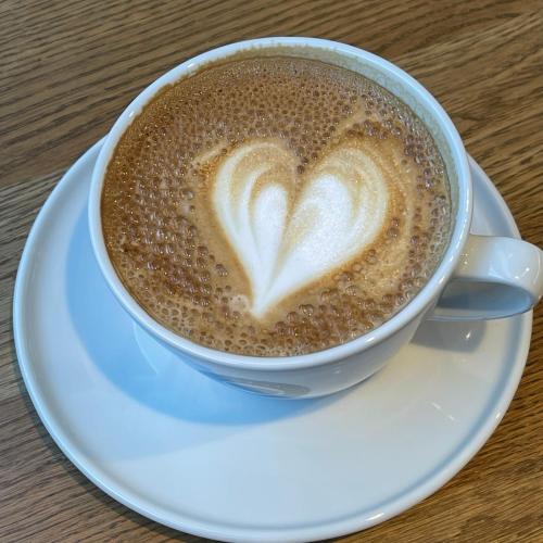 a cup of coffee with a heart painted on it at Senate Hotel in Helsinki