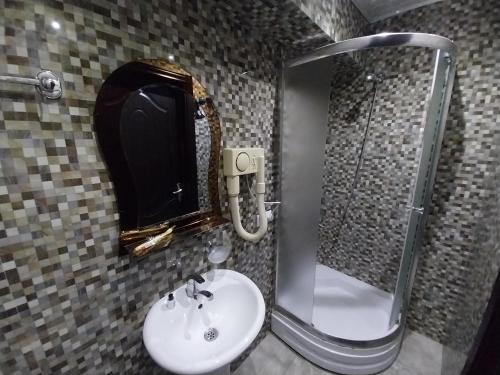 a bathroom with a sink and a mirror at Magnolia in Kutaisi
