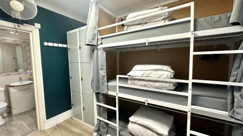 a room with bunk beds and a bathroom at Smart Hyde Park View Hostel in London
