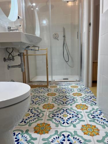 a bathroom with a shower and a toilet and a sink at Casa San Domingo in Marina di Camerota