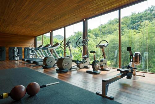 a gym with a lot of treadmills and elliptical machines at Six Senses Yao Noi in Ko Yao Noi