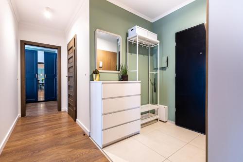 a bathroom with a sink and a mirror at Apartamenty City Tower od WroclawApartament-pl in Wrocław