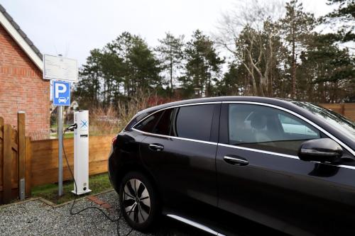 a car is parked next to a parking meter at Hotel Das kleine Glück - Adults Only in Sankt Peter-Ording