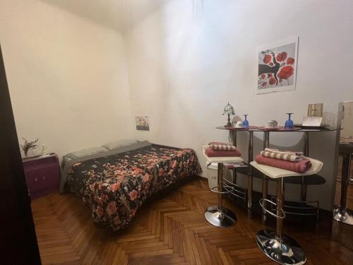 a bedroom with a bed and a table and chairs at La Vie de Bohème in Trieste