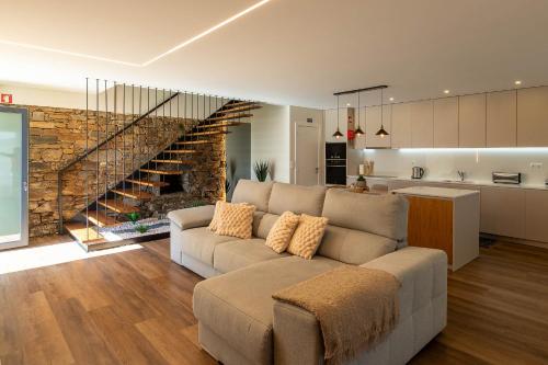 a living room with a couch and a kitchen at Casa da Quebrada, Douro in Lamego