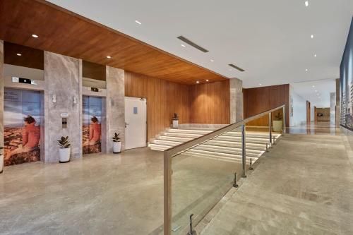 a lobby of a building with a staircase in it at Holiday Inn Express Bengaluru Bommasandra by IHG in Bengaluru