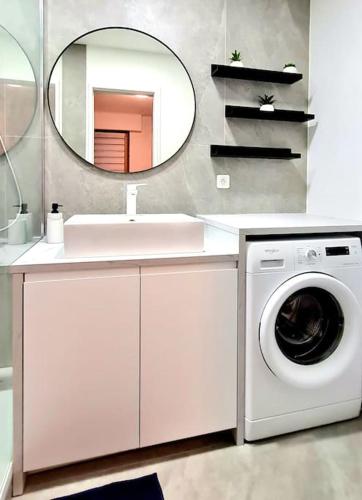 a bathroom with a washing machine and a mirror at Ma Bulle d Aix superbe studio tout confort in Aix-les-Bains