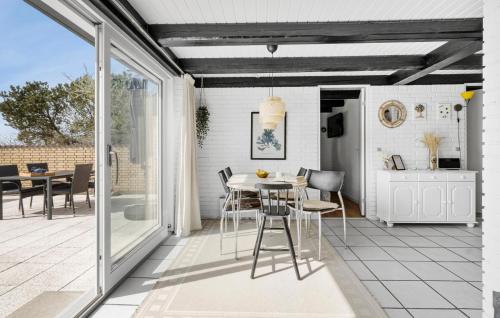 a kitchen and dining room with a table and chairs at Stunning Home In Fårevejle With Kitchen in Fårevejle