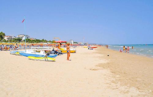 a group of people on a beach with boats at Nice Apartment In Castilenti With Wifi in Castilenti