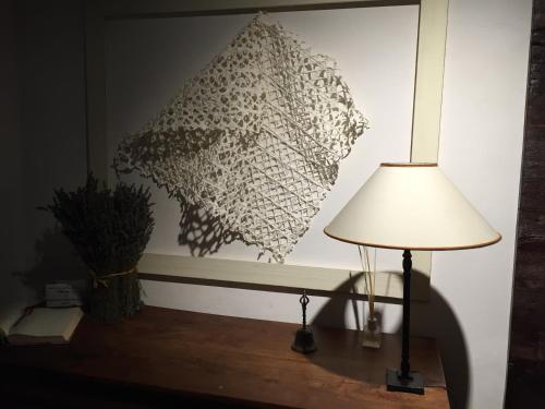 a lamp sitting on a table next to a wall at Casina Mazzuoli in Città della Pieve