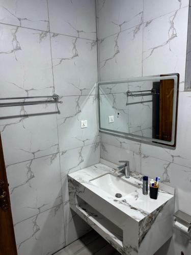 a white bathroom with a sink and a mirror at Ruhondo Beach Resort in Ruhengeri