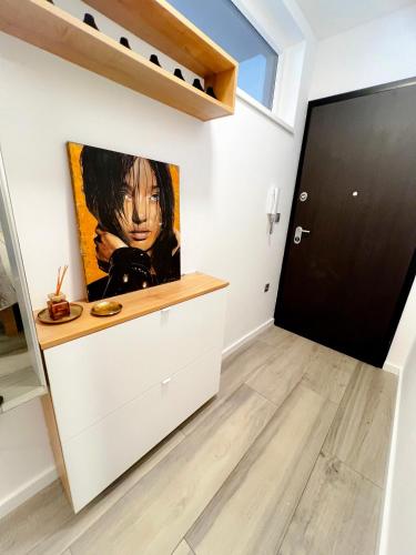 a living room with a painting on the wall at LuxArt City Spa Gallery Residence Krk in Krk