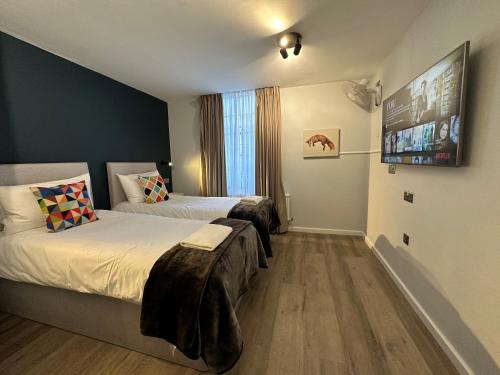 a bedroom with two beds and a large window at Smart Hyde Park View Hostel in London