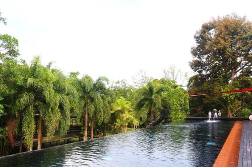a canal in a park with palm trees at 05 - Exquisite Paradise Retreat in Nai Thon Beach