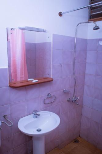 a bathroom with a sink and a mirror at STC.SAFARI LODGE in Oldeani