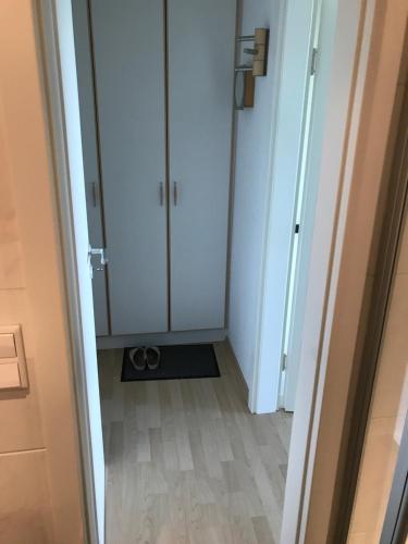 a hallway with a white cabinet and a floor at Sunnyside 95 in Timmendorfer Strand