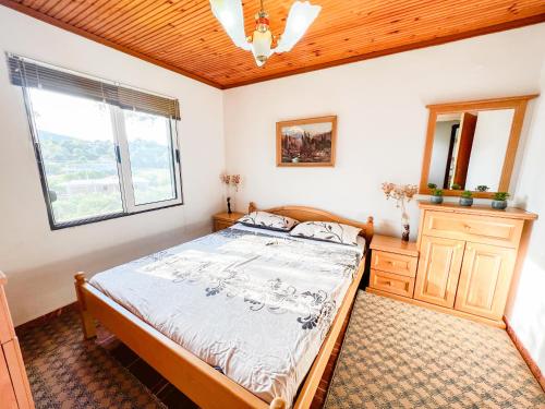 a bedroom with a bed and a window at Hilja's Oliven Garden Bungalows in Ulcinj