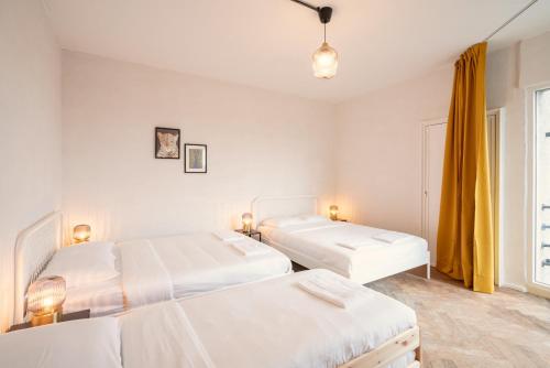 a bedroom with two beds and a window at Charming and Spacious Apartments in the Heart of Antwerp in Antwerp