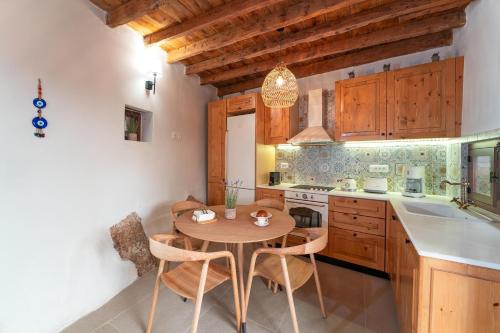 a kitchen with a table and chairs in a room at Rodos Old Town Aqua Luxury Suites in Rhodes Town