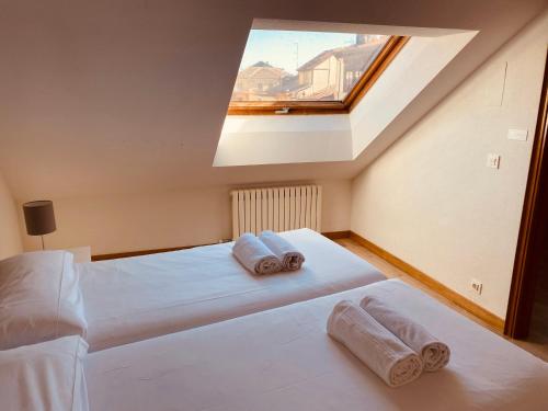 a bedroom with two beds and a skylight at San Pablo 2 parking opcional by Salamancavacacional in Salamanca