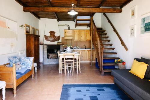 a living room with a staircase and a table and chairs at Selvicolle Country House in Crispiero