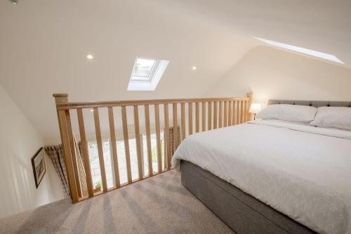 a bedroom with a bed and a stair case at Little Croft in Kettlewell