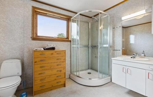 a bathroom with a shower and a toilet and a sink at 5 Bedroom Cozy Home In ydegard 