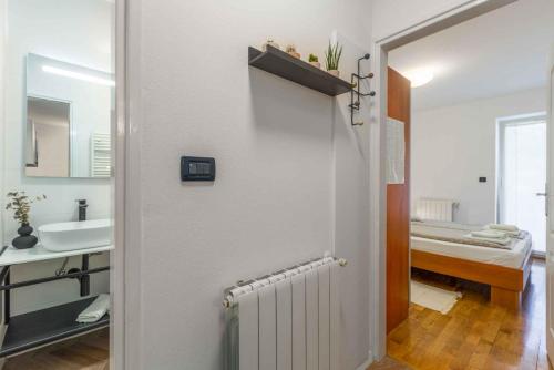 a bathroom with a hallway with a radiator and a bed at Apartment in Porec/Istrien 10331 in Poreč