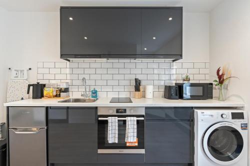 a kitchen with a sink and a stove top oven at Free Parking Ideal for solo business travellers in Ilkeston