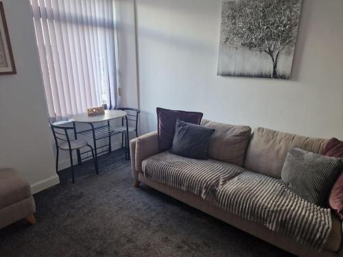 a living room with a couch and a table at M Rooms - entire 1 bedroom, furnished pub flat in Kirk of Shotts
