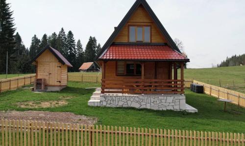 a small wooden cabin with a red roof at Braća Kosorić in Han Pijesak