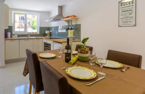 a dining room table with a bottle of wine and glasses at Ferienhaus für 4 Personen ca 47 qm in Crikvenica, Kvarner Bucht Crikvenica und Umgebung in Crikvenica