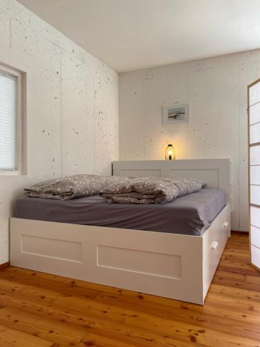a bedroom with a white bed in a room at Green Mountain Retreat in Fliess