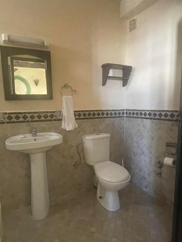 a bathroom with a toilet and a sink at Riad Al Madina in Essaouira