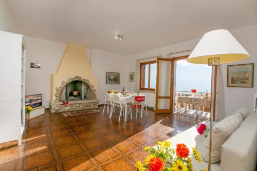 a living room with a couch and a fireplace at Balcone Panoramico sul Garda in Tremosine Sul Garda